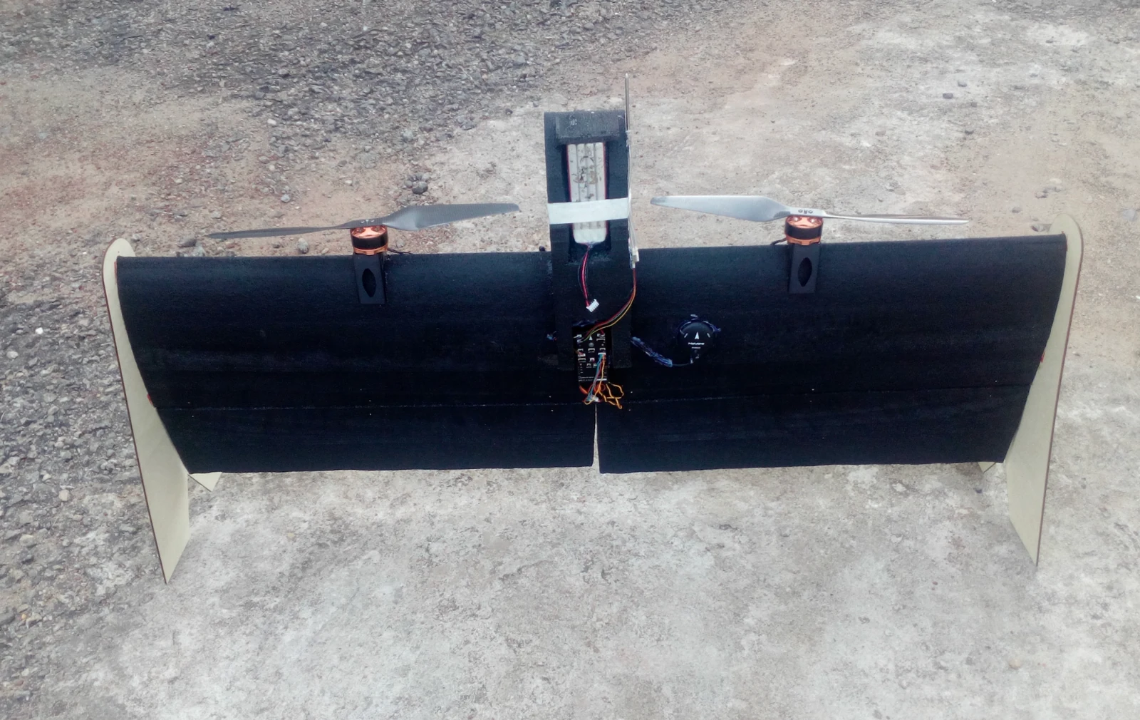 The team’s early twin-motor tailsitter with exposed wiring, showing the first physical test airframe